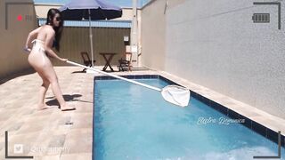 Very hot brunette cleaning the pool