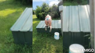 Wife posing with harley outdoors.