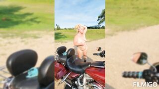 Wife posing with harley outdoors.