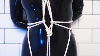 Goddess in latex catsuit tied with ropes