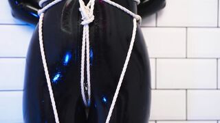 Goddess in latex catsuit tied with ropes