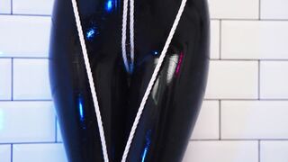 Goddess in latex catsuit tied with ropes