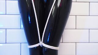 Goddess in latex catsuit tied with ropes