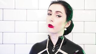 Goddess in latex catsuit tied with ropes