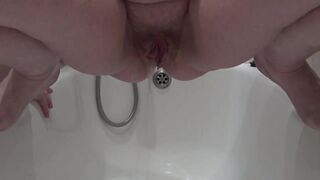 Old hairy pussy pissing close up. Mature MILF with a plump cunt urinates over the bathtub. Do you want her? Fetish. BBW.