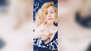 Metal girl smokes a cigarette